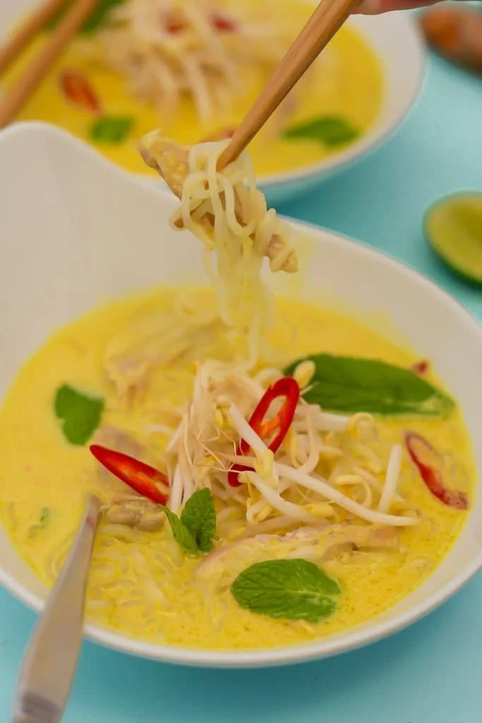 Keto Chicken Laksa Noodle Soup garnished with herbs and spices