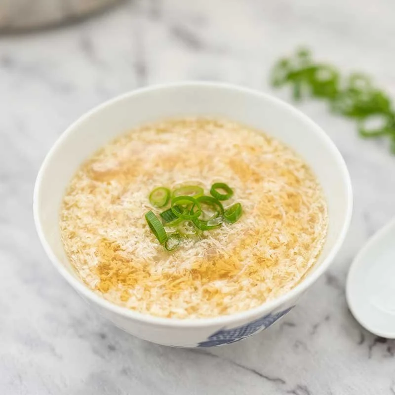 Bowl of Keto Egg Drop Soup with fresh herbs and eggs