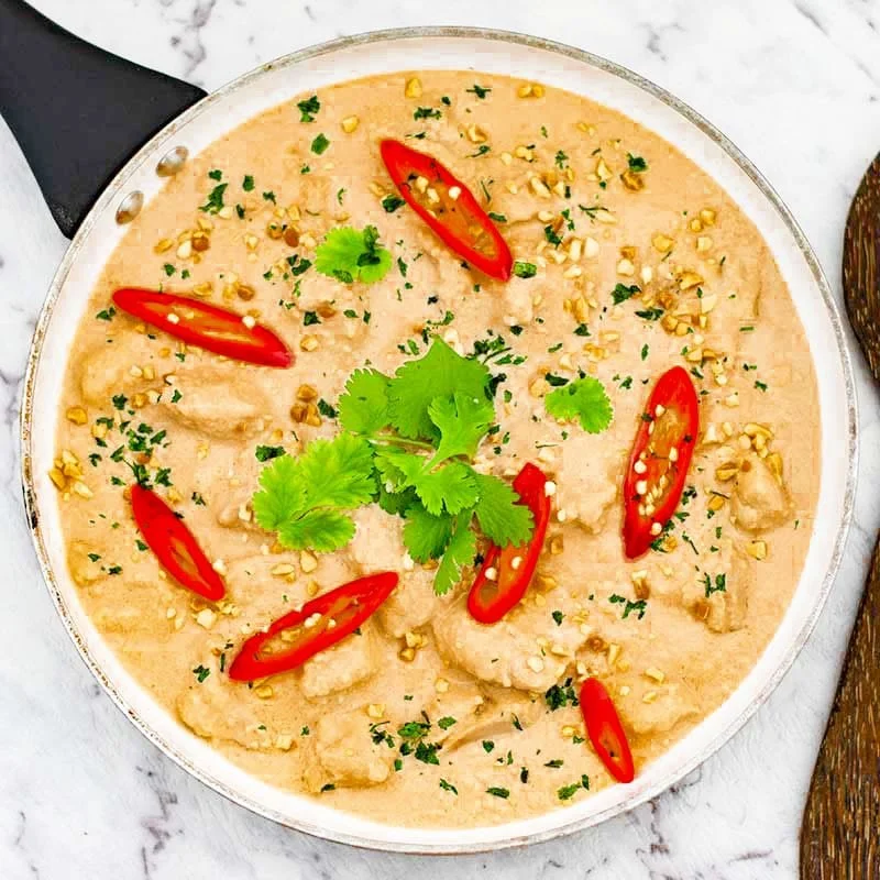 Delicious Keto Satay Chicken Curry served in a bowl with fresh herbs